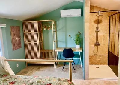 a bedroom with a shower and a desk with a mirror at La Belle Lumière in Saint-Saturnin-les-Apt