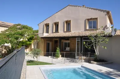 a house with a swimming pool in front of a house at Maison de caractère au coeur de la Provence in Mallemort