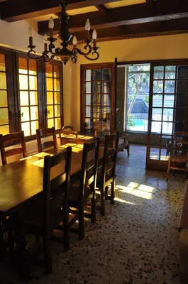 a dining room with a large wooden table and chairs at Maison de caractère au coeur de la Provence in Mallemort