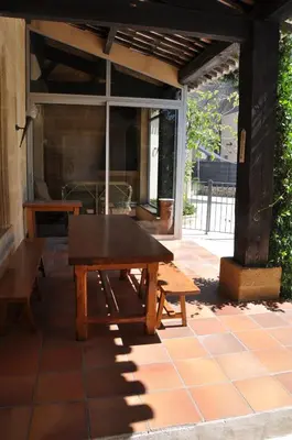a picnic table on the patio of a house at Maison de caractère au coeur de la Provence in Mallemort