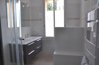 a white bathroom with a sink and a mirror at Maison de caractère au coeur de la Provence in Mallemort