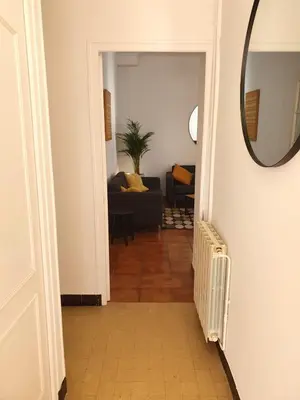 a hallway with a mirror and a living room at Villa Tassigny in Aix-en-Provence