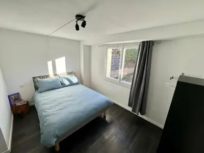 a small bedroom with a bed and a window at Les 2 Oliviers in Caromb