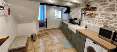 a kitchen with a sink and a washer and dryer at Latipik in Lançon-Provence
