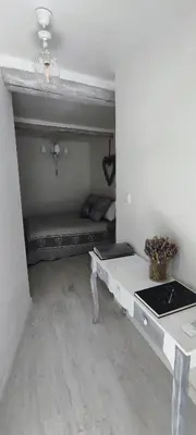 a room with a white table and a couch at Latipik in Lançon-Provence