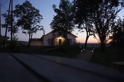 a small house with a light on the side of a road at Masmazan in Mazan