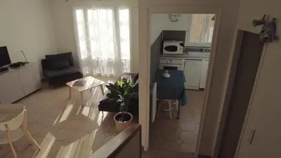 a small kitchen and living room with a table and chairs at Lovely house teracce and parking in historic center in Aix-en-Provence