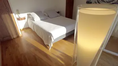 a bedroom with a bed with a light in the foreground at Lovely house teracce and parking in historic center in Aix-en-Provence