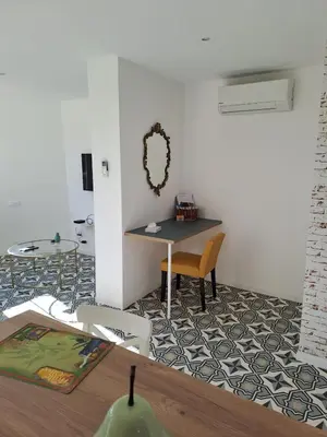 a dining room with a table and a table and chairs at La Petite Maison des Boettes in Carpentras