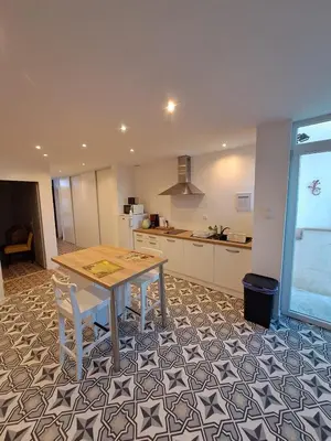 a kitchen with a table and chairs in a room at La Petite Maison des Boettes in Carpentras