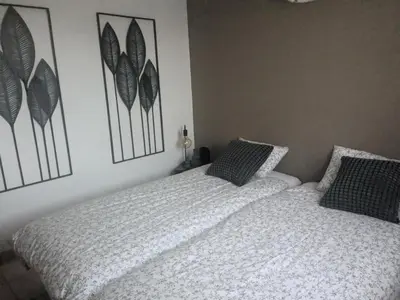 a bedroom with two beds and pictures on the wall at Village Pont Royal en Provence - maeva Home - Appartement climatisé avec terrasse 4 pièces 7 personnes - Prestige - super Home MAE-3801 in Mallemort