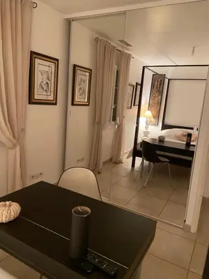 a living room with a table and a dining room at Maison de Golfeur in Mallemort