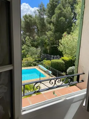 a view of a swimming pool from a window at Maison de Golfeur in Mallemort