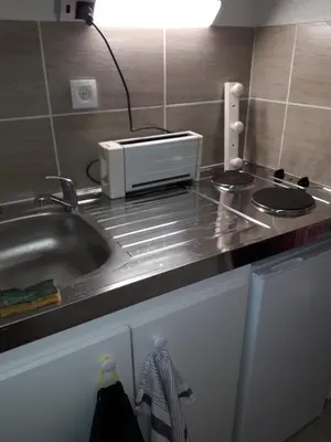 a kitchen counter with a sink and a microwave at Studio 007 à Aix in Aix-en-Provence