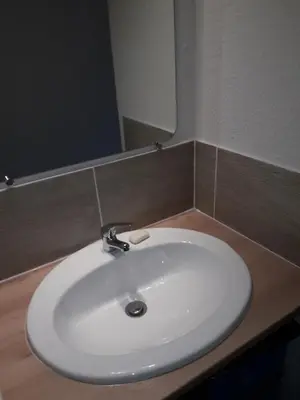 a white sink in a bathroom with a mirror at Studio 007 à Aix in Aix-en-Provence