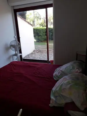 a bedroom with a bed and a window with a fan at Studio 007 à Aix in Aix-en-Provence