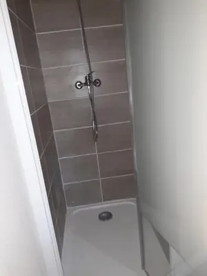 a shower with a shower head in a bathroom at Studio 007 à Aix in Aix-en-Provence