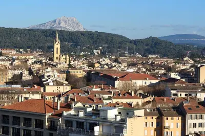 a city with buildings and a mountain in the background at Aix Rooftop Appartement T2 Luxe 5 étoiles - hypercentre Rotonde - Terrasse - Vue - Parking in Aix-en-Provence