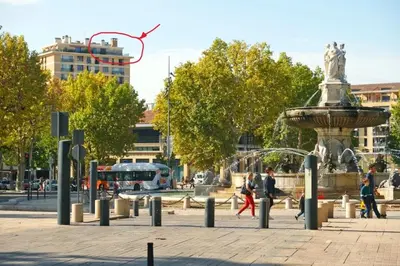 a fountain in a city with people walking around it at Aix Rooftop Appartement T2 Luxe 5 étoiles - hypercentre Rotonde - Terrasse - Vue - Parking in Aix-en-Provence