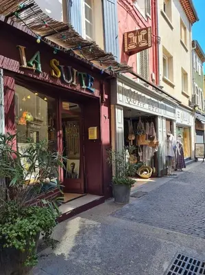 a store on a street in a city with shops at Appartement avec terrasse sur les toits classé 5* in LʼIsle-sur-la-Sorgue
