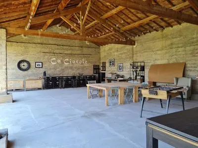 a large room with tables and a sign on the wall at Le Mas du Castellas 5* in Le Thor