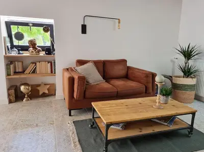 a living room with a couch and a coffee table at Le Mas du Castellas 5* in Le Thor