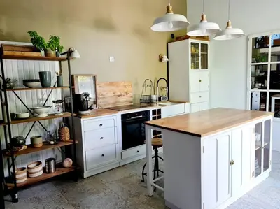 a kitchen with white cabinets and a counter top at Le Mas du Castellas 5* in Le Thor