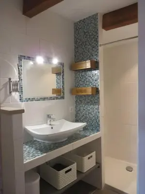a bathroom with a sink and a mirror at Les Tarraïettes au pied du Luberon in Lourmarin