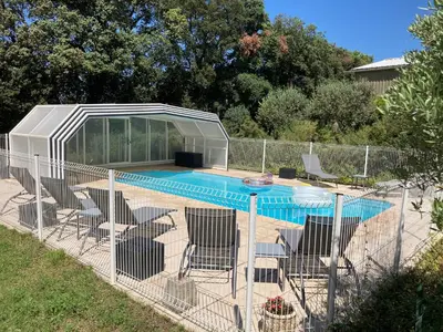 a fence with chairs and a swimming pool at Domaine des Lavarines in Morières-lès-Avignon