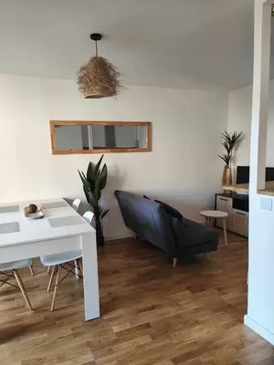 a living room with a couch and a table at Terrasse & Spa dans Aix Hypercentre in Aix-en-Provence