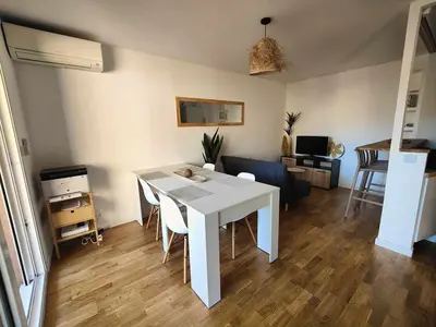 a living room with a white table and chairs at Terrasse & Spa dans Aix Hypercentre in Aix-en-Provence