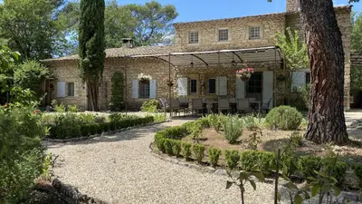 a garden with pink flowers and a tree at Mas de Veroncle, piscine et quiétude à Gordes in Gordes