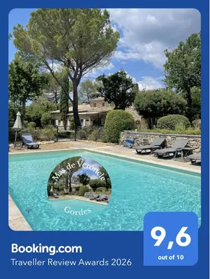 a bedroom with a large bed and a desk at Mas de Veroncle, piscine et quiétude à Gordes in Gordes