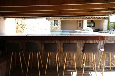 a group of chairs sitting at a bar at Provençal farmhouse, Mont Ventoux view, 2 pools (1 heated), Bédoin - 10 people in Bédoin