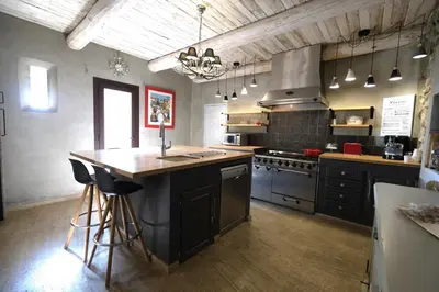 a large kitchen with a island in the middle of it at Provençal farmhouse, Mont Ventoux view, 2 pools (1 heated), Bédoin - 10 people in Bédoin