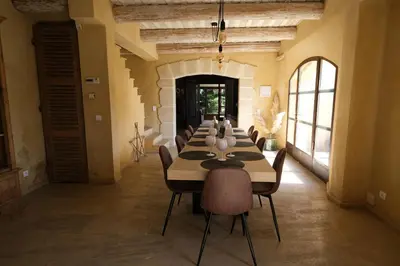 a long dining room with a long table and chairs at Provençal farmhouse, Mont Ventoux view, 2 pools (1 heated), Bédoin - 10 people in Bédoin
