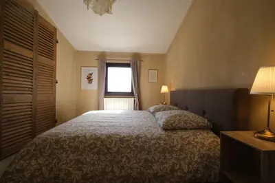 a bedroom with a large bed and a window at Provençal farmhouse, Mont Ventoux view, 2 pools (1 heated), Bédoin - 10 people in Bédoin
