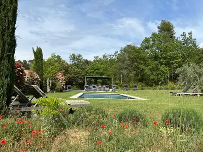 a garden with a swimming pool in the grass at Lou Pantai, Bed and breakfast, small double Bedroom in Aix-en-Provence