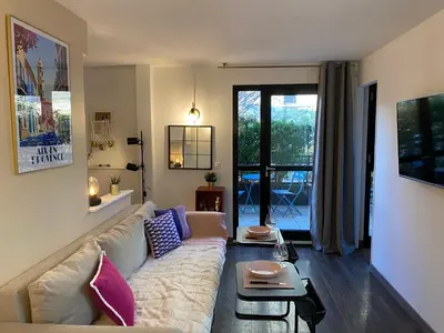 a living room with a couch and a table at Ma place au sud Aix Terrasse Parking in Aix-en-Provence