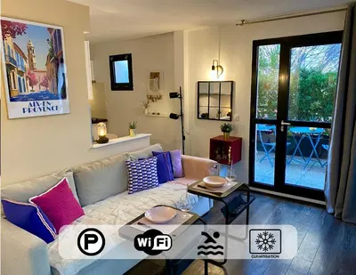 a living room with a couch and a table at Ma place au sud Aix Terrasse Parking in Aix-en-Provence