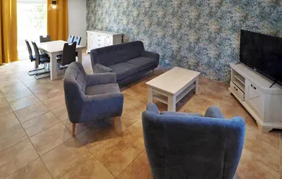 a living room with a couch and chairs and a tv at Zèbre in Eyragues