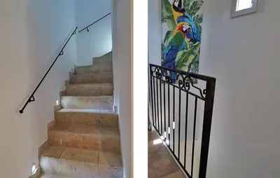 a staircase with a peacock painting on the wall and a stair railing at Zèbre in Eyragues