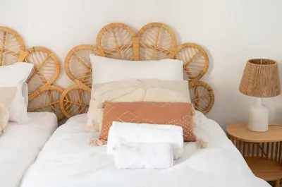 a white bed with a wooden headboard and pillows on it at Deux chambres avec terrasse dans le centre ville d'Aix en Provence in Aix-en-Provence