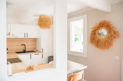a kitchen with white cabinets and a window and a mirror at Deux chambres avec terrasse dans le centre ville d'Aix en Provence in Aix-en-Provence