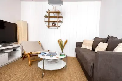 a living room with a couch and a table at CŒUR DU VENTOUX Carpentras Bel appart 6 places in Carpentras