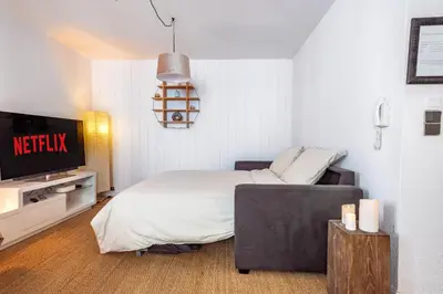 a bedroom with a bed and a flat screen tv at CŒUR DU VENTOUX Carpentras Bel appart 6 places in Carpentras
