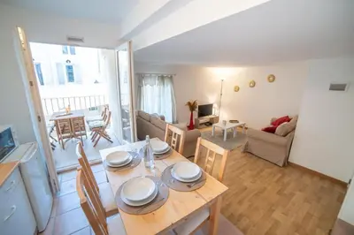 a kitchen and living room with a table and chairs at L'évasion de Bedoin, appartement in Bédoin