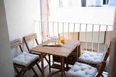 a wooden table with two chairs and a table with drinks on it at L'évasion de Bedoin, appartement in Bédoin