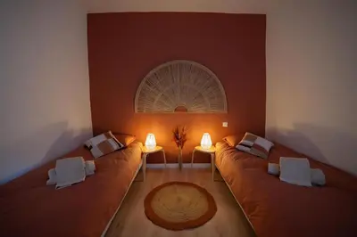 a living room with two brown couches and two lamps at L'évasion de Bedoin, appartement in Bédoin