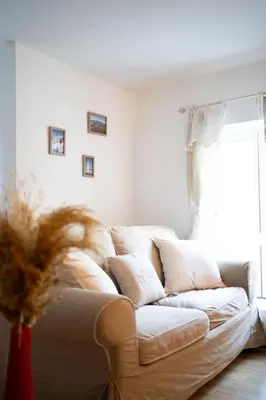 a white couch in a living room with a window at L'évasion de Bedoin, appartement in Bédoin